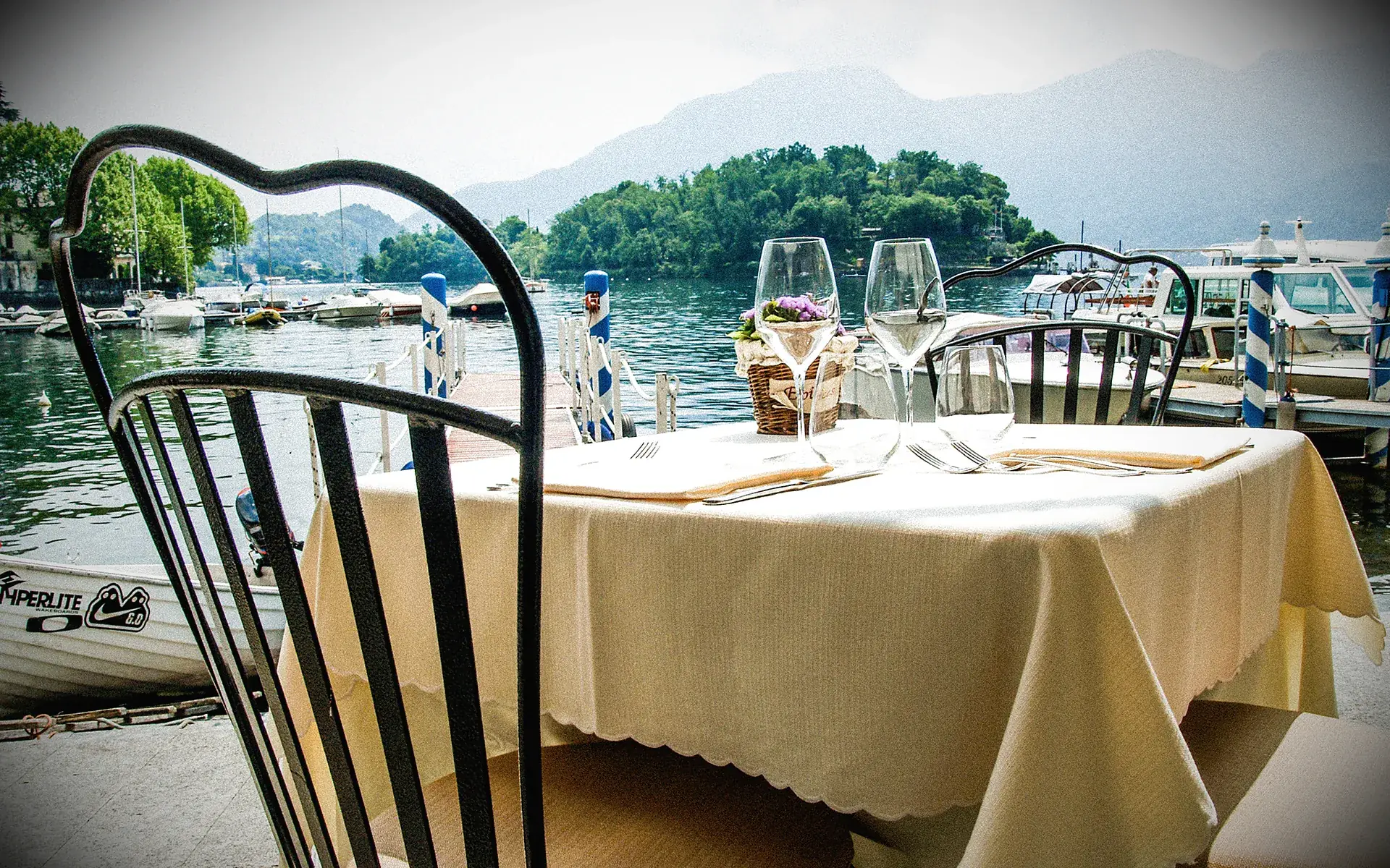 A table set at La Tirlindana by the lake, opposite Isola Comacina